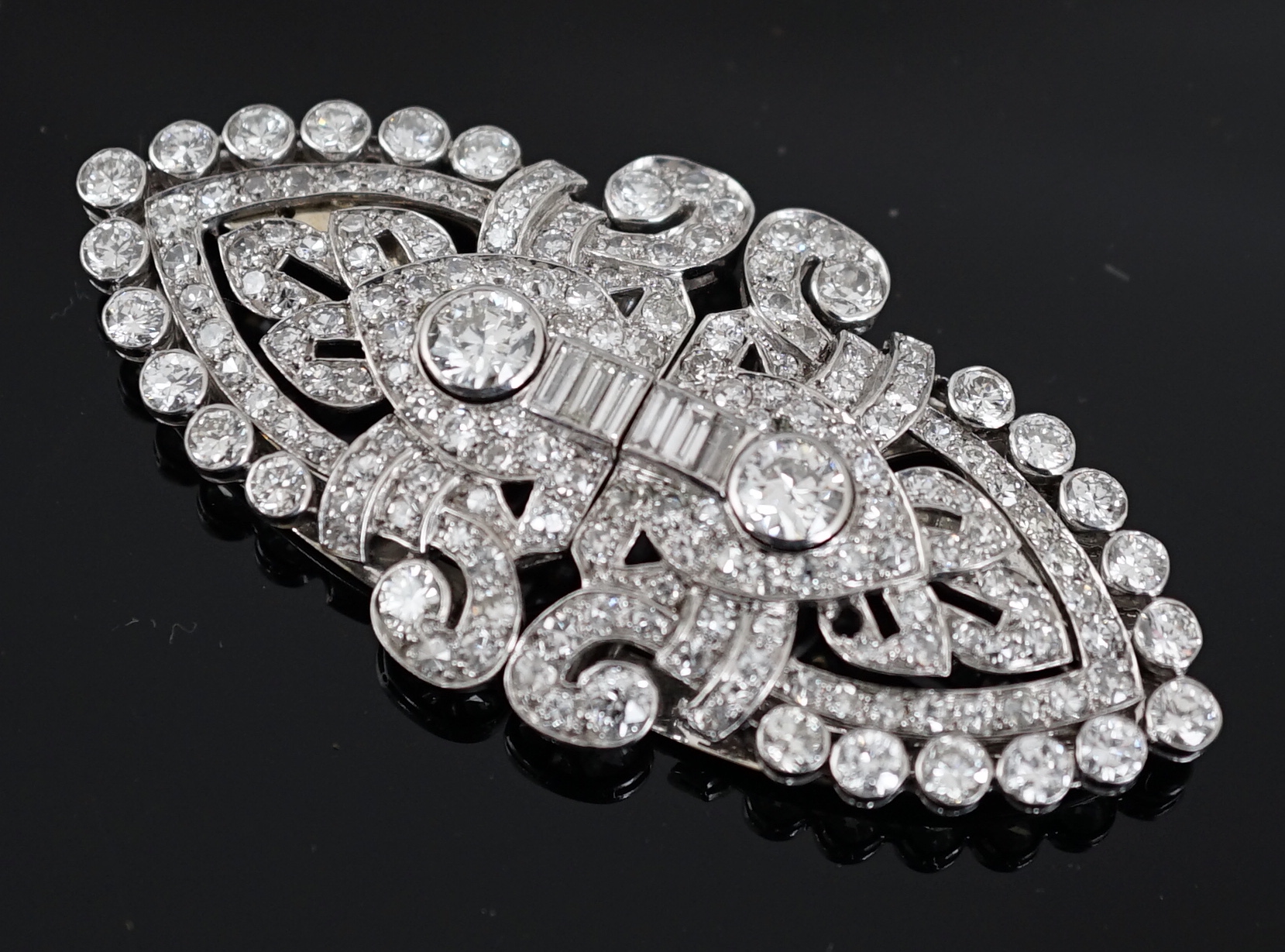 An Art Deco white gold, round and baguette cut diamond set double clip brooch